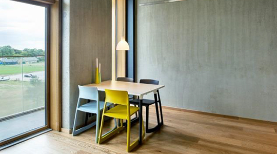 The image shows the apartment's dining area with table and chairs.