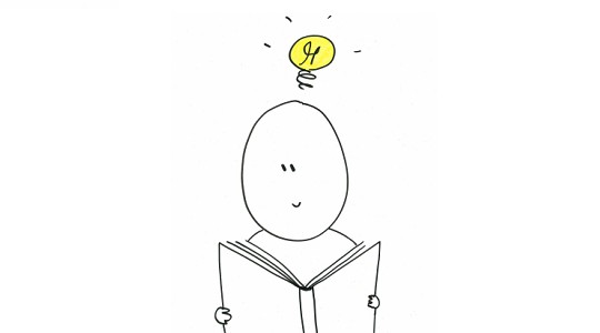 Et billede af en studerende, som læser i en bog